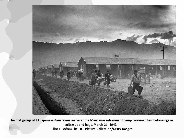 The first group of 82 Japanese-Americans arrive at the Manzanar internment camp carrying their