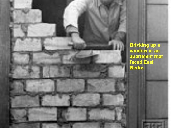 Bricking up a window in an apartment that faced East Berlin. 