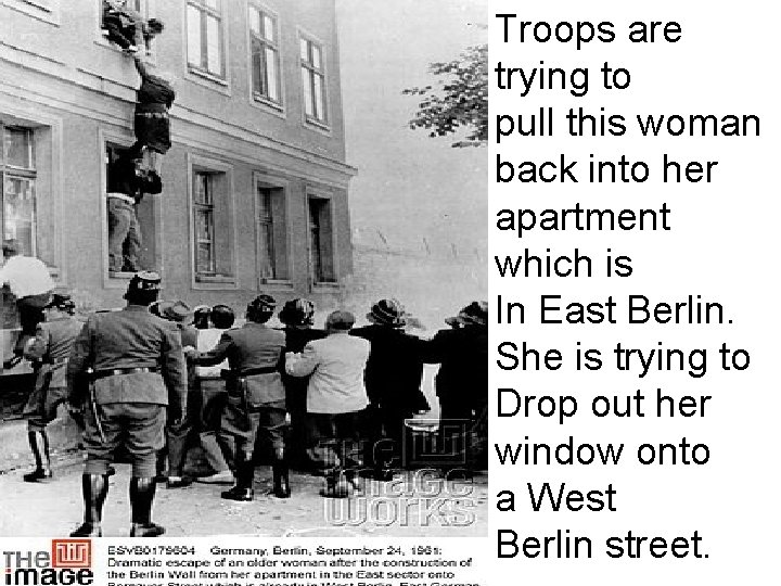 Troops are trying to pull this woman back into her apartment which is In