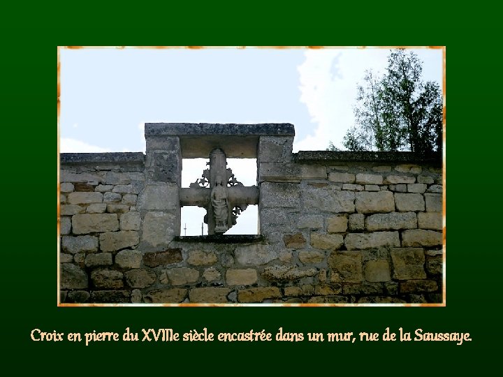 Croix en pierre du XVIIIe siècle encastrée dans un mur, rue de la Saussaye.