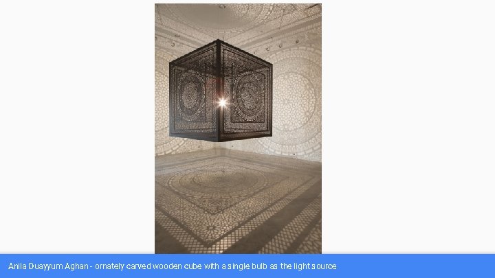 Anila Ouayyum Aghan - ornately carved wooden cube with a single bulb as the
