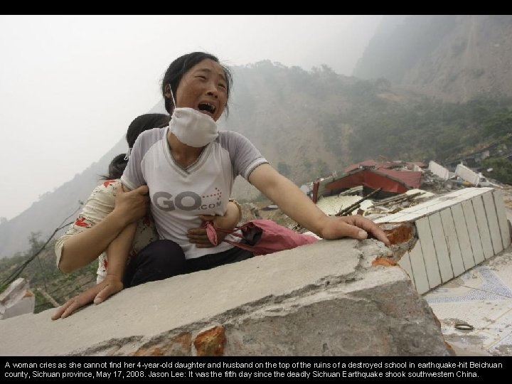 A woman cries as she cannot find her 4 -year-old daughter and husband on