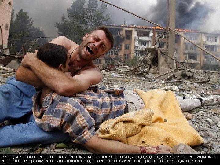 A Georgian man cries as he holds the body of his relative after a
