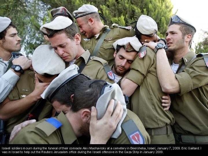 Israeli soldiers mourn during the funeral of their comrade Alex Mashavisky at a cemetery