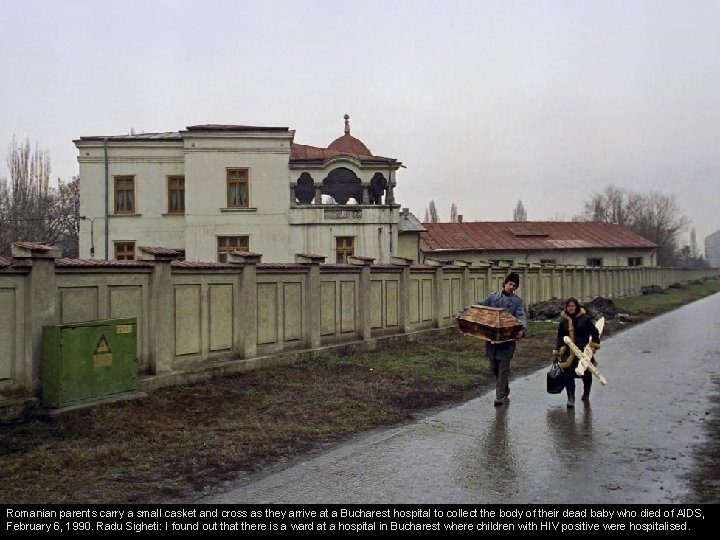 Romanian parents carry a small casket and cross as they arrive at a Bucharest