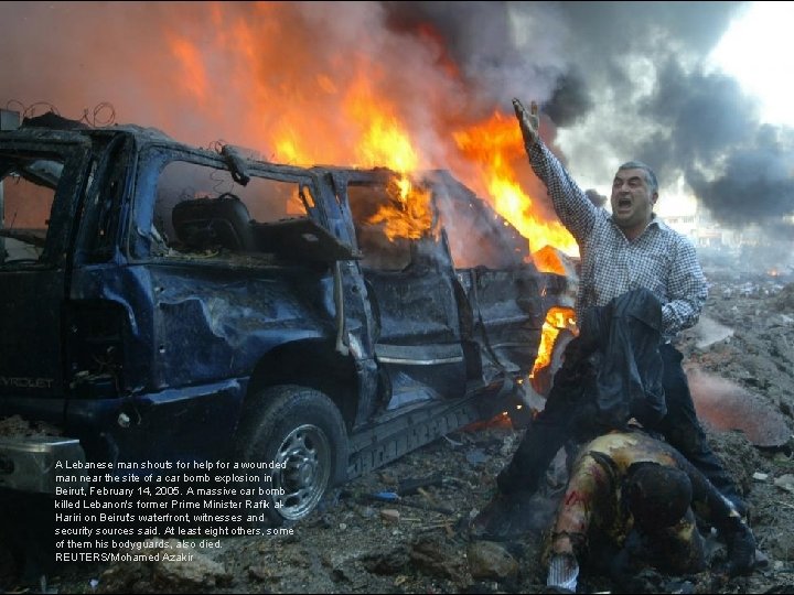 A Lebanese man shouts for help for a wounded man near the site of