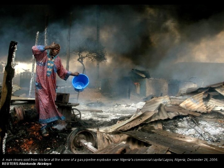 A man rinses soot from his face at the scene of a gas pipeline