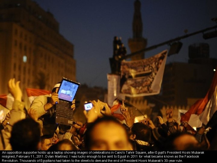 An opposition supporter holds up a laptop showing images of celebrations in Cairo's Tahrir