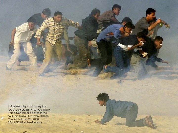 Palestinians try to run away from Israeli soldiers firing teargas during Palestinian-Israeli clashes in