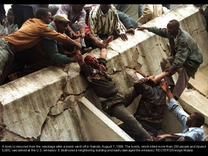 A body is removed from the wreckage after a bomb went off in Nairobi,