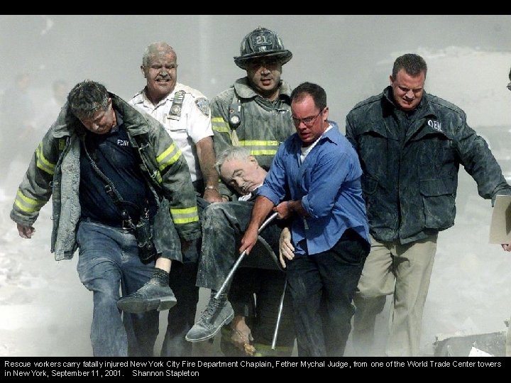 Rescue workers carry fatally injured New York City Fire Department Chaplain, Fether Mychal Judge,