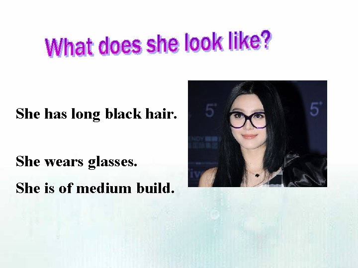 She has long black hair. She wears glasses. She is of medium build. 