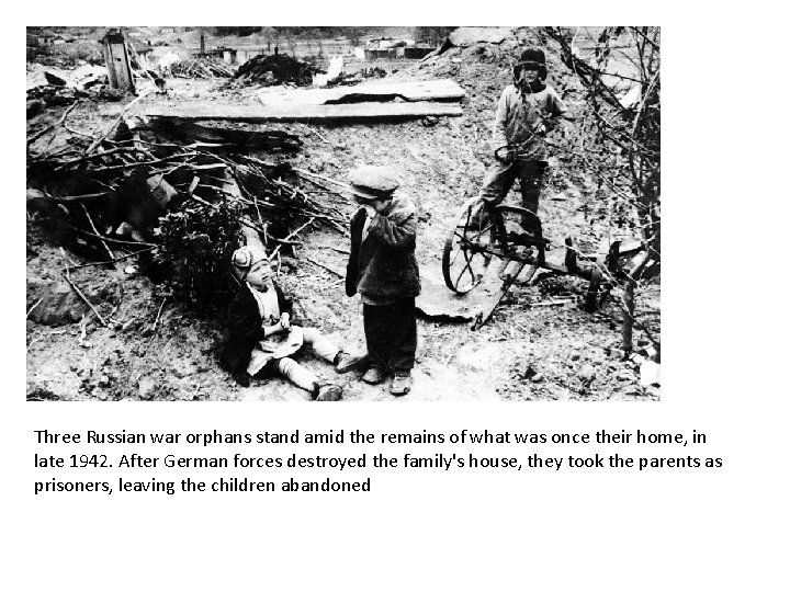 Three Russian war orphans stand amid the remains of what was once their home,