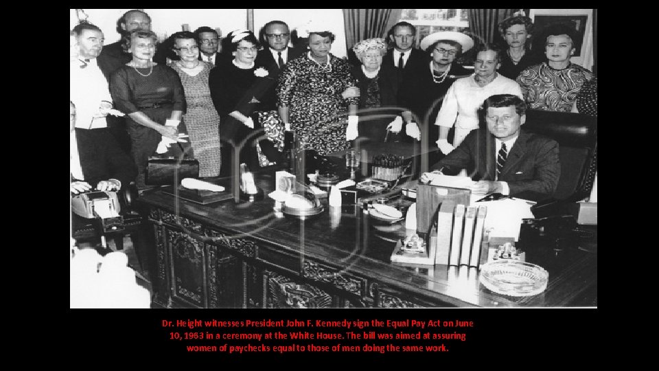Dr. Height witnesses President John F. Kennedy sign the Equal Pay Act on June