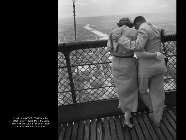 A couple enjoys the view from the Eiffel Tower in 1952. More than 250