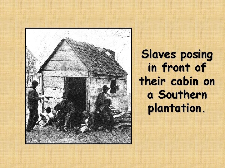 Slaves posing in front of their cabin on a Southern plantation. 