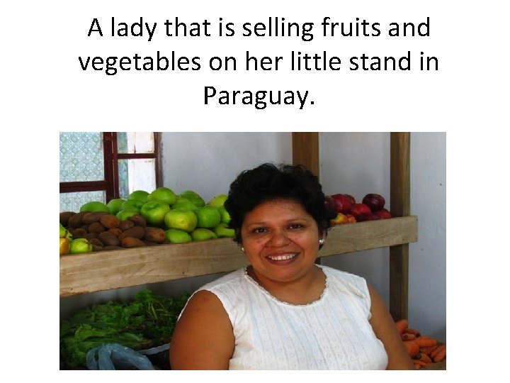 A lady that is selling fruits and vegetables on her little stand in Paraguay.