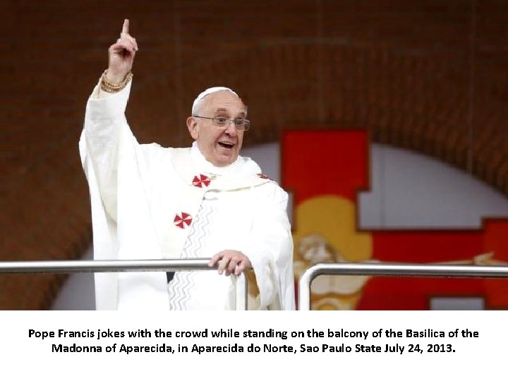 Pope Francis jokes with the crowd while standing on the balcony of the Basilica