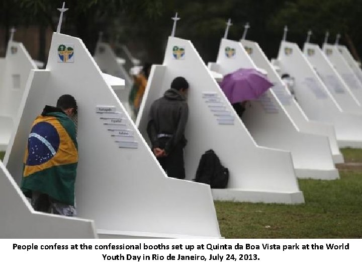 People confess at the confessional booths set up at Quinta da Boa Vista park