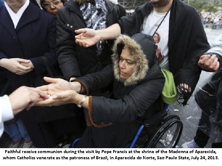 Faithful receive communion during the visit by Pope Francis at the shrine of the