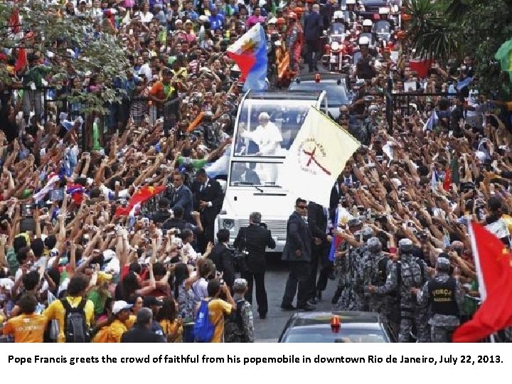 Pope Francis greets the crowd of faithful from his popemobile in downtown Rio de
