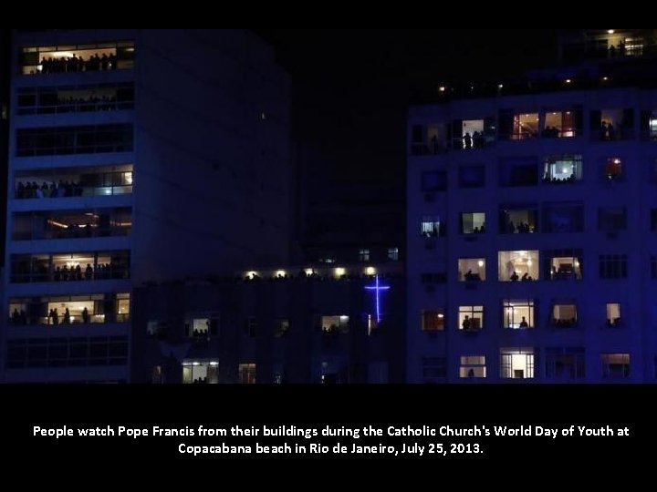 People watch Pope Francis from their buildings during the Catholic Church's World Day of