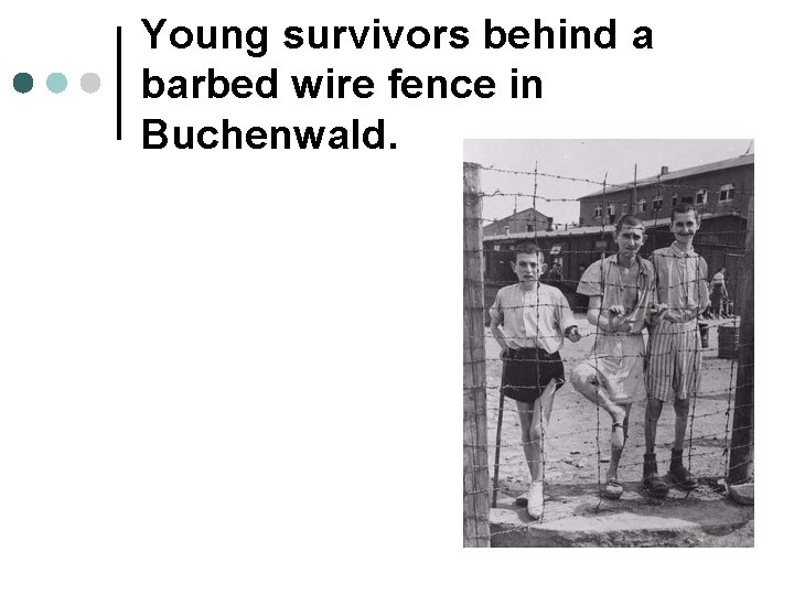 Young survivors behind a barbed wire fence in Buchenwald. 