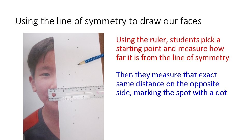 Using the line of symmetry to draw our faces Using the ruler, students pick