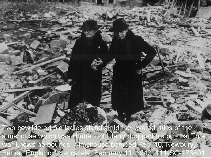 Two bewildered old ladies stand amid the leveled ruins of the almshouse which was