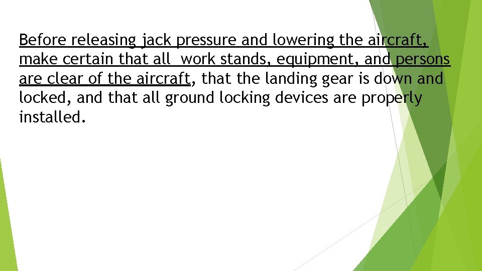 Before releasing jack pressure and lowering the aircraft, make certain that all work stands,