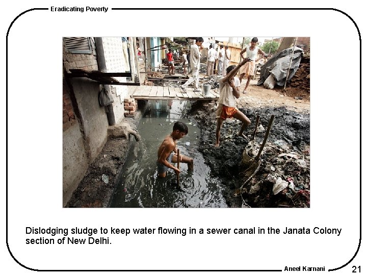 Eradicating Poverty Dislodging sludge to keep water flowing in a sewer canal in the Eradicating Poverty Dislodging sludge to keep water flowing in a sewer canal in the