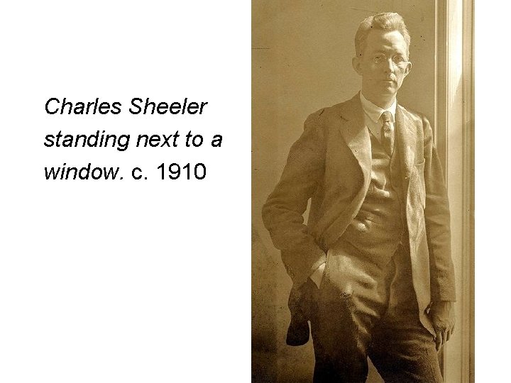 Charles Sheeler standing next to a window. c. 1910 