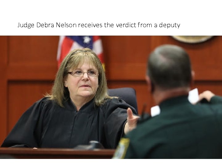 Judge Debra Nelson receives the verdict from a deputy 