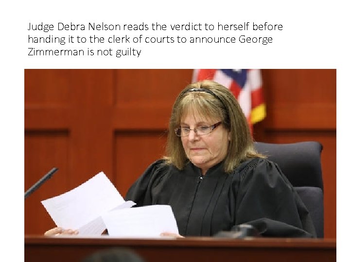 Judge Debra Nelson reads the verdict to herself before handing it to the clerk