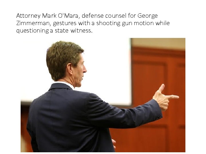 Attorney Mark O'Mara, defense counsel for George Zimmerman, gestures with a shooting gun motion