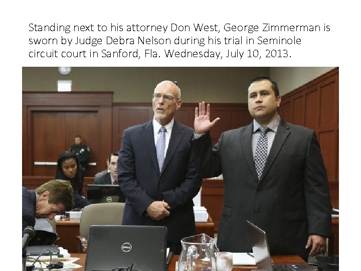 Standing next to his attorney Don West, George Zimmerman is sworn by Judge Debra
