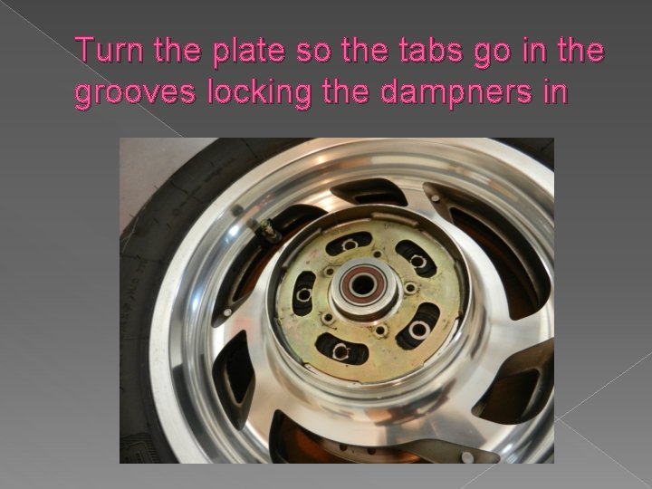 Turn the plate so the tabs go in the grooves locking the dampners in
