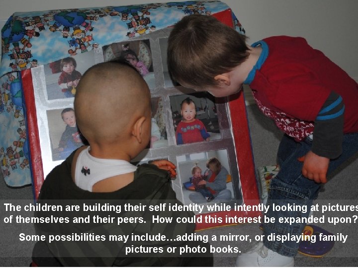 The children are building their self identity while intently looking at pictures of themselves