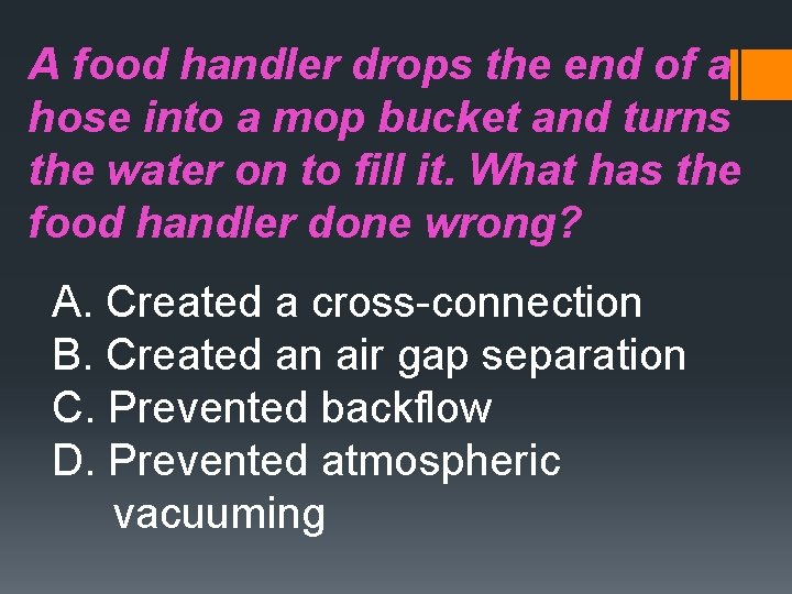 A food handler drops the end of a hose into a mop bucket and