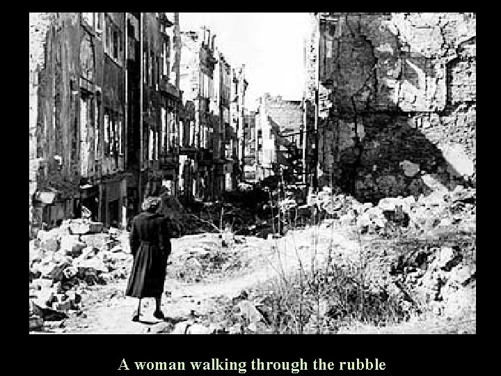 A woman walking through the rubble 