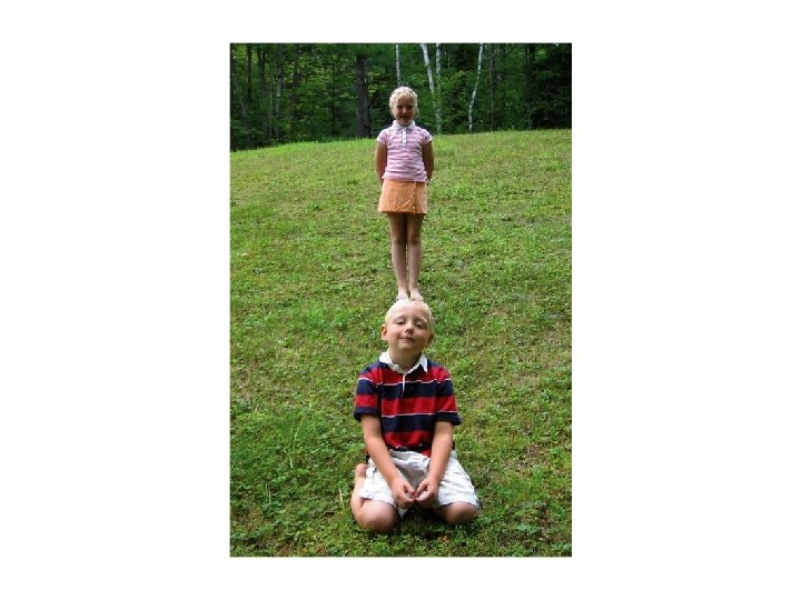 Picture of a young boy with a tiny girl appearing to be standing directly Picture of a young boy with a tiny girl appearing to be standing directly