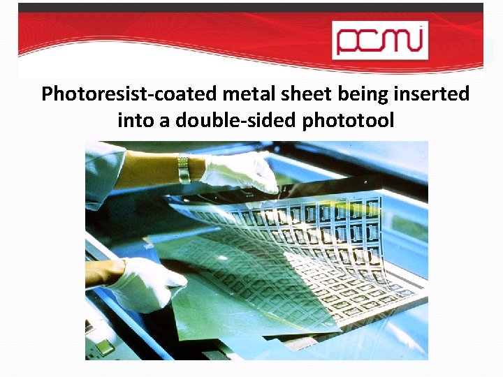Photoresist-coated metal sheet being inserted into a double-sided phototool 