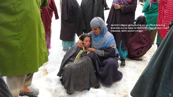 Kashmiri villagers gather during rescue efforts following landslides due to heavy rainfall in the