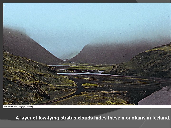 A layer of low-lying stratus clouds hides these mountains in Iceland. 