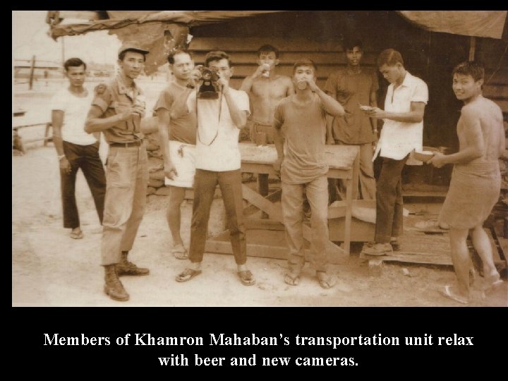 Members of Khamron Mahaban’s transportation unit relax with beer and new cameras. 