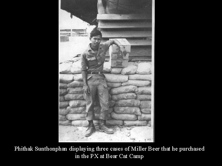 Phithak Sunthonphan displaying three cases of Miller Beer that he purchased in the PX