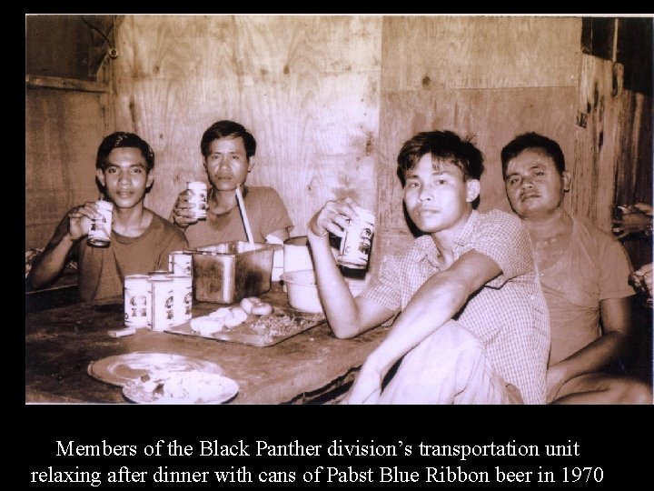 Members of the Black Panther division’s transportation unit relaxing after dinner with cans of