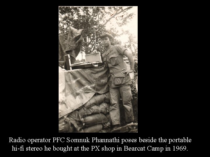Radio operator PFC Somnuk Phannathi poses beside the portable hi-fi stereo he bought at