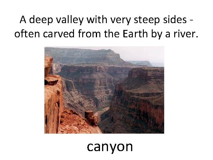 A deep valley with very steep sides often carved from the Earth by a