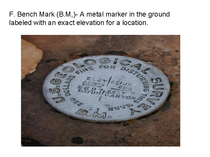 F. Bench Mark (B. M, )- A metal marker in the ground labeled with